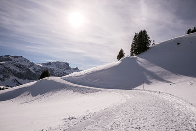 Scenic view of snow covered mountains against sky