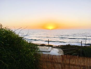 Scenic view of sea against clear sky during sunset