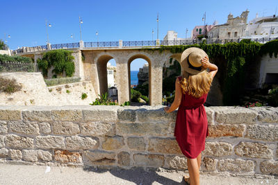 Holidays in italy. young tourist woman in polignano a mare, apulia, italy.