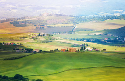 Scenic view of agricultural field and buildings