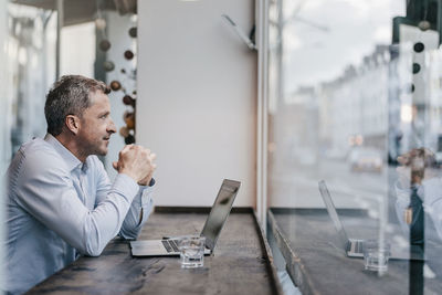 Businessman sitting in cafe, working