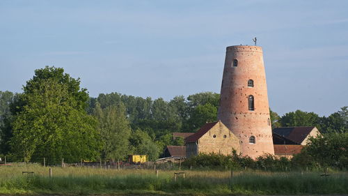 Built structure on field against sky