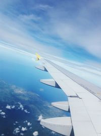 Aerial view of aircraft wing against sky