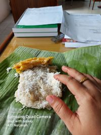 Close-up of hand holding food on table