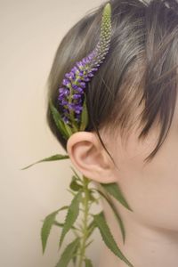 Close-up portrait of woman with purple flower