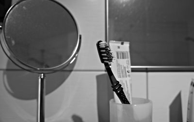 Close-up of toothbrush and toothpaste in bathroom