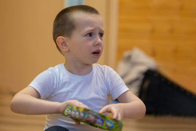 Little boy cries from grief and resentment. he wipes tears from his cheek with his hand.