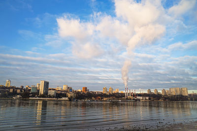 Panoramic view of river by buildings against sky