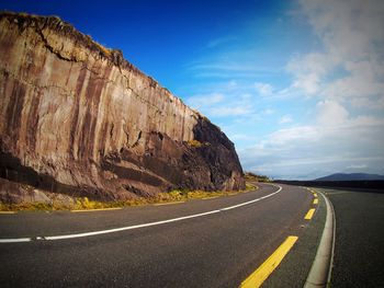 Scenic view of road amidst landscape against sky