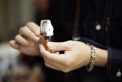 Cropped image of woman holding cigarette