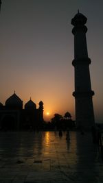 Silhouette of building against sky during sunset
