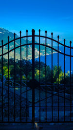 Metal fence against blue sky