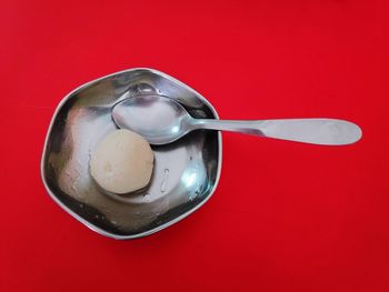 High angle view of ice cream against red background