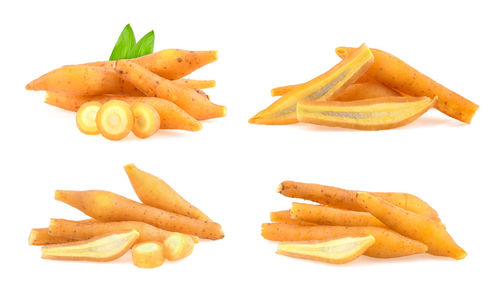 Close-up of fries and orange on white background