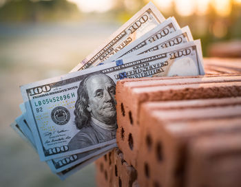 Close-up of us paper currency on brick 