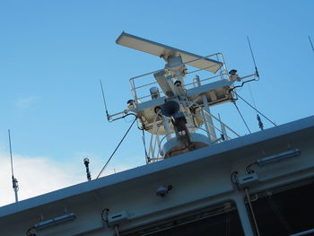 Low angle view of traditional windmill against clear blue sky
