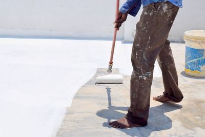 Low section of man standing on footpath