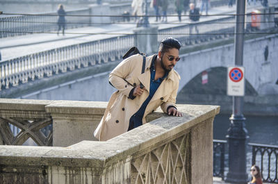 Young man looking down at bridge