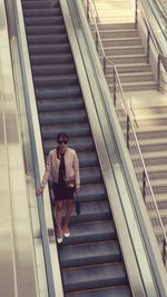 Low angle view of man on escalator