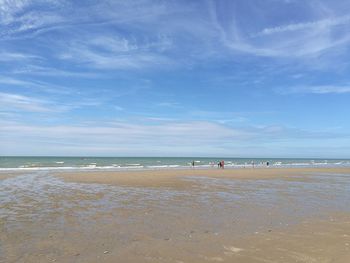 View of beach against cloudy sky