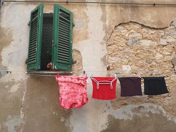 Clothes drying against wall of old building