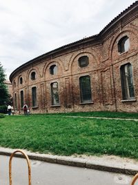 Man in front of historic building against sky