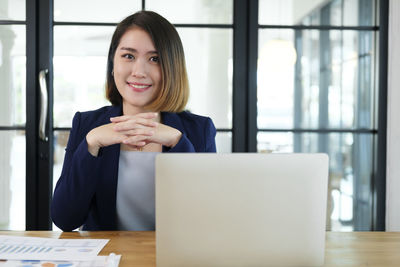 Portrait of a young woman using phone