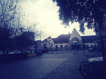 Empty road with buildings in background
