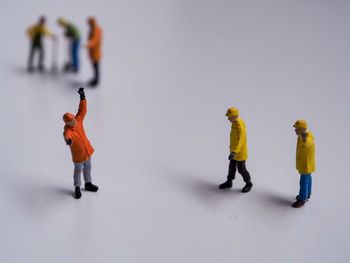 Full length of people with toy against white background
