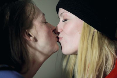 Close-up of lesbian couple kissing at home