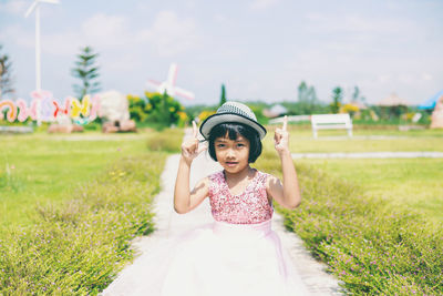 Full length of cute girl standing on field