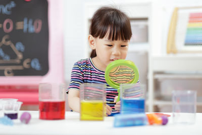 Portrait of cute baby boy on table