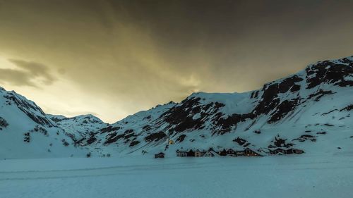 Scenic view of snow covered mountains against sky