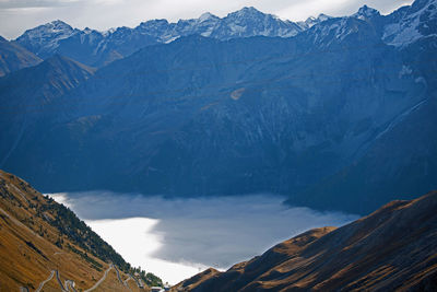 Scenic view of mountains against cloudy sky