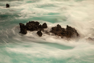 Scenic view of sea against rocks