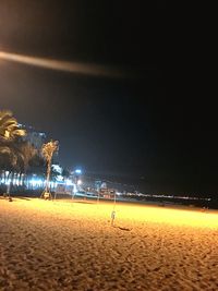 Scenic view of beach against clear sky at night