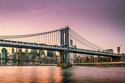 Golden gate bridge over river against sky in city