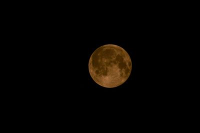 Low angle view of moon against sky at night