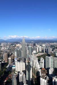 View of cityscape against blue sky