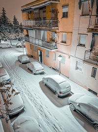 Aerial view of snow covered street and buildings in city