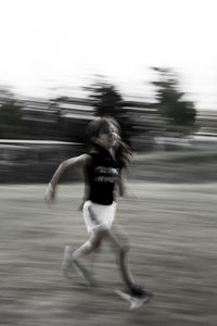 Rear view of woman running on water