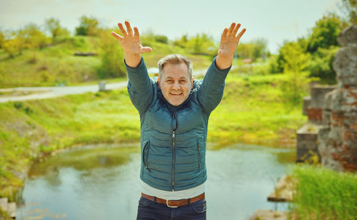 Portrait of smiling young man standing in water