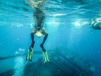 Low section of woman swimming in pool