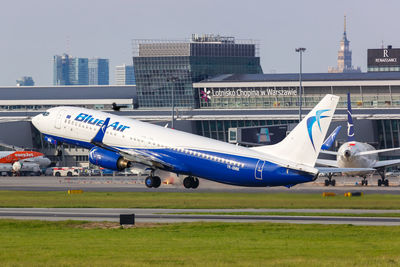 Airplane on airport runway against sky