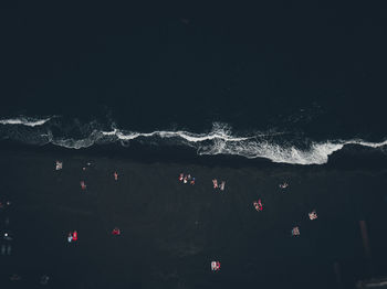 High angle view of illuminated sea against sky at night