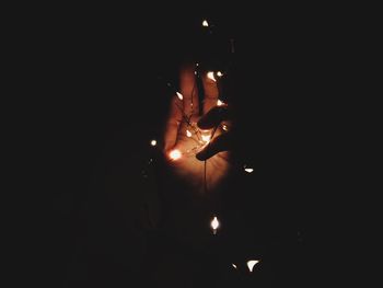 Lit candles in darkroom