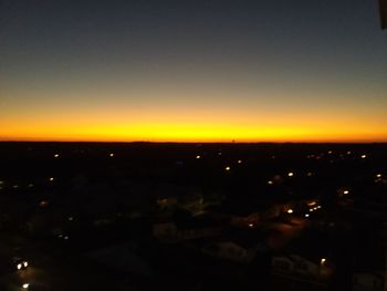 High angle view of illuminated buildings against sky at sunset