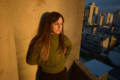 Portrait of a beautiful young woman in city