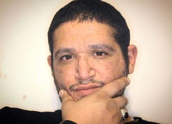 Close-up portrait of a serious young man over white background