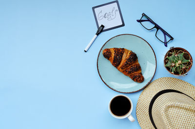 Low angle view of breakfast served on table against blue background